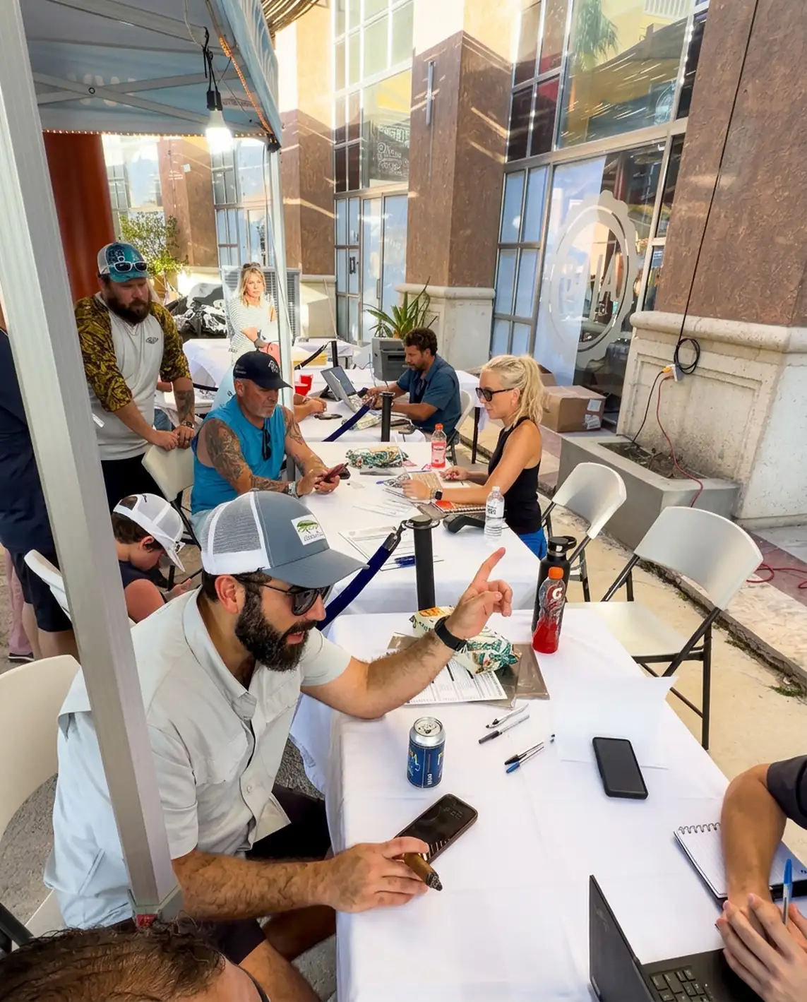 Tournament staff register teams at the Bisbee's check-in tables outside Puerto Paraíso mall