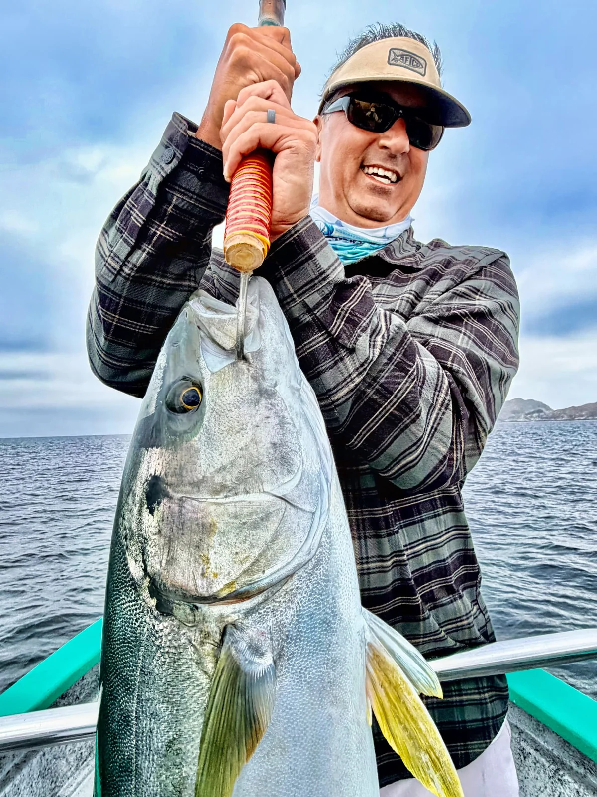 An angler holds a yellowtail during the Cedros Island trip.