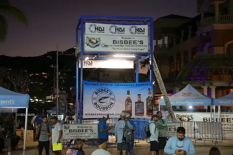 Bisbee’s tournament tower and anglers beside the Cabo San Lucas marina at dusk.