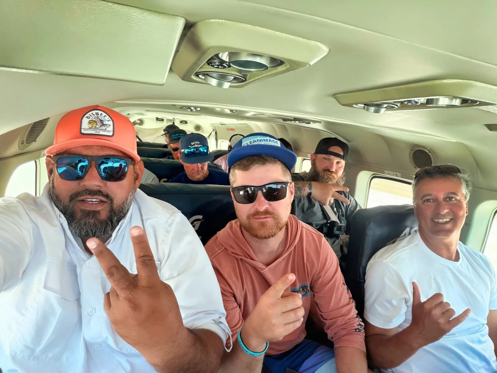 Arturo Chacón and fellow anglers take a selfie inside the small plane flying to Isla Cedros